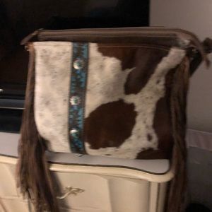 Cow skin purses with leather fringes on side
